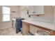 Functional laundry room with modern washer, dryer, countertop, storage, and natural light at 15298 Windward Ln, Lancaster, SC 29720