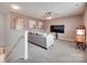 Comfortable upstairs living room with neutral tones, a plush sofa, and a flat-screen TV at 15298 Windward Ln, Lancaster, SC 29720