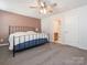 Main bedroom with king bed, en-suite bathroom access, and ceiling fan at 15298 Windward Ln, Lancaster, SC 29720