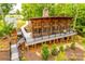 A screened outdoor living area and deck offer serene views of landscaped backyard at 15298 Windward Ln, Lancaster, SC 29720