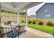 Relaxing covered patio featuring comfortable seating and a ceiling fan, perfect for outdoor entertaining at 15298 Windward Ln, Lancaster, SC 29720