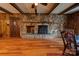 Stone fireplace in the dining area with wood floors at 1602 Eaves Rd, Shelby, NC 28152