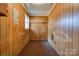 Laundry room with wooden walls and shelving at 1602 Eaves Rd, Shelby, NC 28152