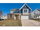 Brick and gray two-story home with a two-car garage and landscaped lawn at 1615 Cannonball Ln, Bessemer City, NC 28016