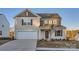 Two-story house with neutral siding, a white garage door, and landscaping at 1717 Wooten Way, Bessemer City, NC 28016