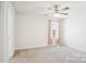 Neutral bedroom featuring plush carpeting, a ceiling fan, and a window at 17311 Carolina Hickory Dr, Huntersville, NC 28078