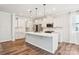 Well-lit kitchen showcasing a center island, stainless steel appliances, and elegant pendant lights at 17311 Carolina Hickory Dr, Huntersville, NC 28078