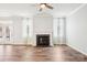 Bright living room featuring hardwood floors, a fireplace, and large windows with natural light at 17311 Carolina Hickory Dr, Huntersville, NC 28078