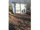 House with backyard, covered patio, and plenty of leaf covered ground at 1827 Mcdonald St, Charlotte, NC 28216