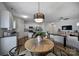 Kitchen and dining area with light wood flooring and modern light fixture at 193 Audra Faye Ln, Indian Trail, NC 28079