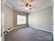 Bright bedroom with ceiling fan, carpet, and large window at 2923 Meadow Creek Ln, Monroe, NC 28110