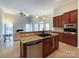 Island kitchen features granite countertops, stainless steel appliances, and open layout to Gathering room at 2923 Meadow Creek Ln, Monroe, NC 28110