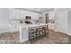 White kitchen with island, quartz countertops, and stainless steel appliances at 4276 Black Ct # 228, Harrisburg, NC 28075