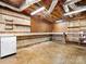 Unfinished basement workshop with workbenches and storage at 4333 Tipperary Pl, Charlotte, NC 28215