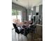 Bright dining area with glass table and four black chairs at 529 Elmwood Pond Ct, Charlotte, NC 28214