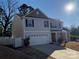 Two-story house with gray siding, stone accents, and a two-car garage at 529 Elmwood Pond Ct, Charlotte, NC 28214