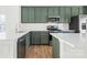 Modern kitchen with green cabinets, white quartz countertops, and stainless steel appliances at 543 San Marco Dr # 16, Gastonia, NC 28056