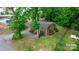 Single story brick home with a tree-filled backyard and surrounding landscape at 61 17Th Street Nw Pl, Hickory, NC 28601