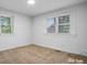 Bright bedroom with neutral walls, carpet flooring, and two windows at 61 17Th Street Nw Pl, Hickory, NC 28601
