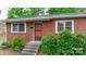 Brick ranch house with steps leading to the front door, surrounded by landscaping at 61 17Th Street Nw Pl, Hickory, NC 28601