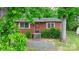 Front view of a red brick house with a yard and mature trees at 61 17Th Street Nw Pl, Hickory, NC 28601