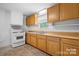 Kitchen features wood cabinets, white appliances, and a double sink at 61 17Th Street Nw Pl, Hickory, NC 28601