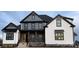 New construction home featuring a mix of modern white siding and gray-toned finishes and a welcoming stone-accented porch at 6507 Rehobeth Rd # 4, Waxhaw, NC 28173