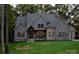 A lush green lawn complements this beautifully crafted home with stone, brick, and complementary gray toned siding at 6507 Rehobeth Rd # 4, Waxhaw, NC 28173