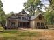 A spacious home with a combination of brick and stone, complemented by a well-manicured lawn and mature trees at 6507 Rehobeth Rd # 4, Waxhaw, NC 28173