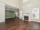 Living room with hardwood floors, fireplace, and view into kitchen at 7617 Red Mulberry Way, Charlotte, NC 28273