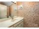 Small half bathroom with nautical-themed wallpaper and single sink vanity at 130 Sandy Shore Dr, Mooresville, NC 28117