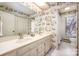 Double vanity bathroom with floral wallpaper and bathtub at 130 Sandy Shore Dr, Mooresville, NC 28117