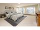 Spacious bedroom with lake view, virtually staged with large bed and rug at 130 Sandy Shore Dr, Mooresville, NC 28117