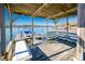 Covered boat dock with seating and water access at 130 Sandy Shore Dr, Mooresville, NC 28117