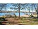 Lakefront property with sandy beach and lush trees at 130 Sandy Shore Dr, Mooresville, NC 28117