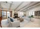 Spacious living room with fireplace and access to a deck overlooking the lake at 130 Sandy Shore Dr, Mooresville, NC 28117