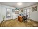 Home office with wood desk, chair, and large windows at 130 Sandy Shore Dr, Mooresville, NC 28117