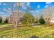 Spacious backyard with a brick home and lush green grass at 144 Spring Forest Dr, Shelby, NC 28152