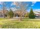 Landscaped backyard showcasing a brick home and mature trees at 144 Spring Forest Dr, Shelby, NC 28152
