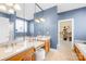 Bathroom features double vanity, large mirrors, and access to a walk-in closet at 144 Spring Forest Dr, Shelby, NC 28152
