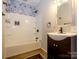 Bright bathroom featuring decorative tile accent wall, wood floors, shower and vanity at 1448-1 New Prospect Church Rd, Shelby, NC 28150