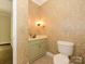 Charming half-bath with floral wallpaper and sage-green vanity at 1448-1 New Prospect Church Rd, Shelby, NC 28150