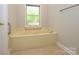 A built-in bathtub under a bright window offering ample natural light at 1448-1 New Prospect Church Rd, Shelby, NC 28150