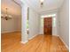 Spacious foyer showcasing hardwood floors and a traditional chandelier at 1448-1 New Prospect Church Rd, Shelby, NC 28150