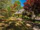 Traditional home showcasing mature trees and lush landscaping highlighting its natural beauty at 1448-1 New Prospect Church Rd, Shelby, NC 28150