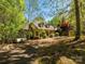 Charming front exterior with dormer windows and a covered front porch, surrounded by trees at 1448-1 New Prospect Church Rd, Shelby, NC 28150