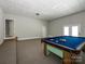 Expansive game room boasts a full-sized pool table, carpet, and easy exterior access at 1448-1 New Prospect Church Rd, Shelby, NC 28150