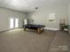 Spacious game room featuring a pool table, carpet, and doors to the exterior at 1448-1 New Prospect Church Rd, Shelby, NC 28150