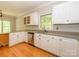 Bright kitchen with white cabinetry, stainless steel dishwasher, and hardwood floors at 1448-1 New Prospect Church Rd, Shelby, NC 28150