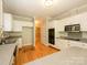 Well-lit kitchen with white cabinets, granite counters, stainless steel appliances and hardwood floors at 1448-1 New Prospect Church Rd, Shelby, NC 28150